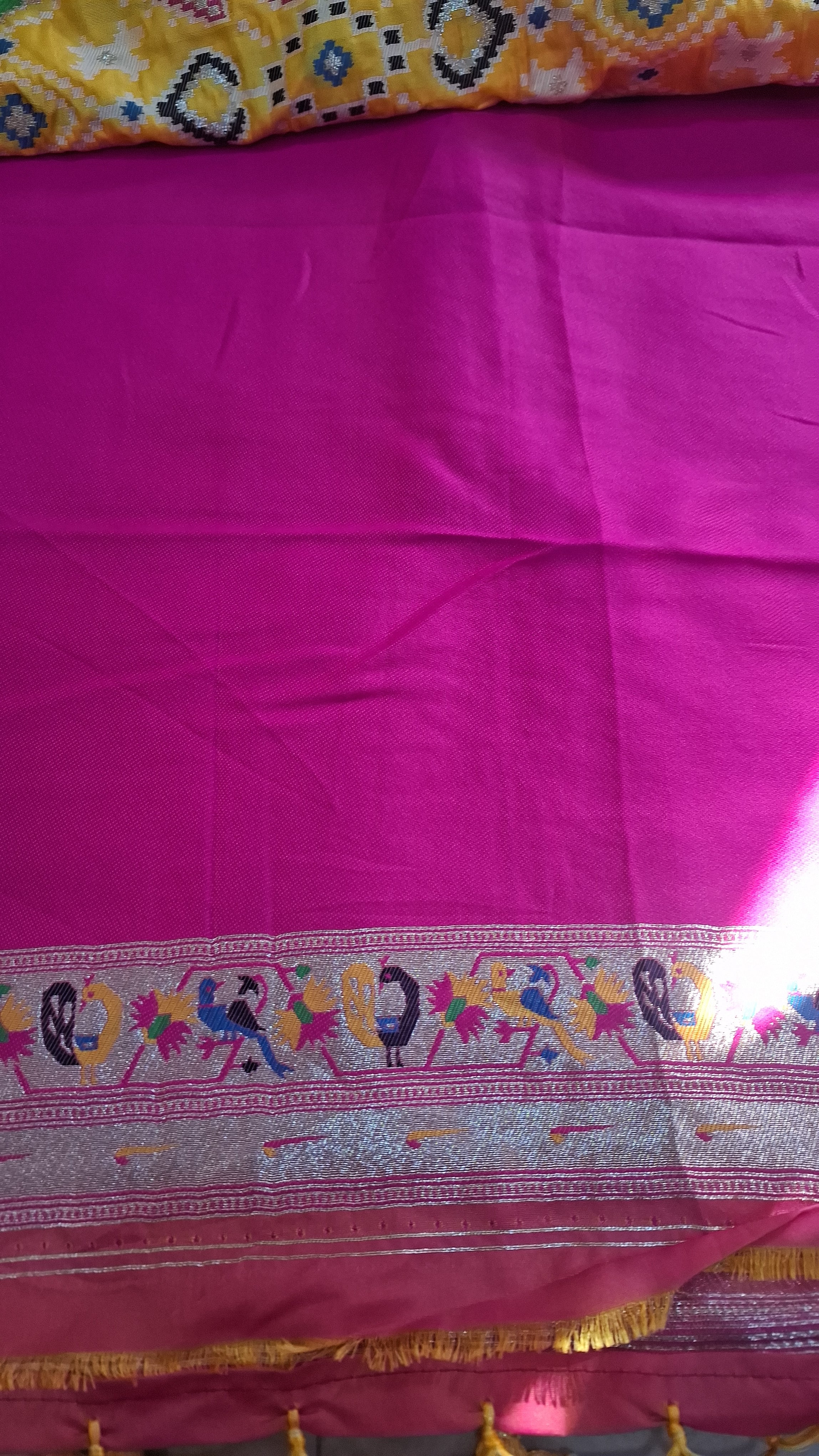 Mustard yellow patola silk saree with rani pink border