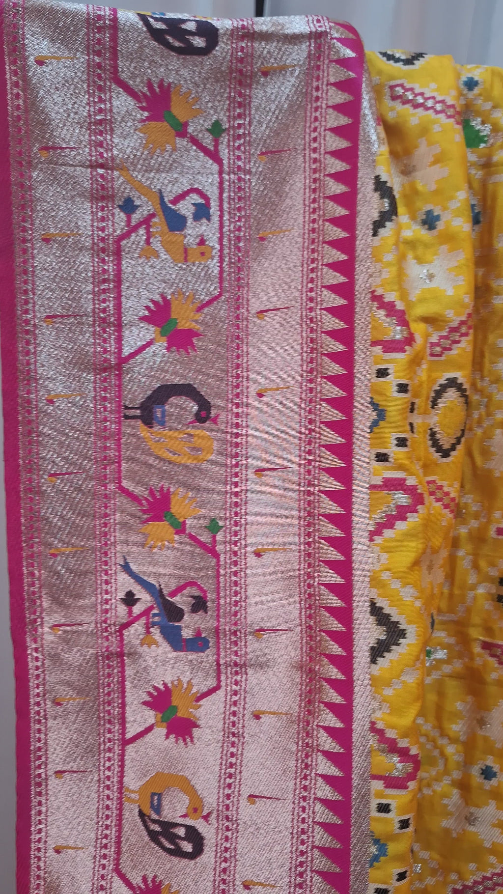 Mustard yellow patola silk saree with rani pink border